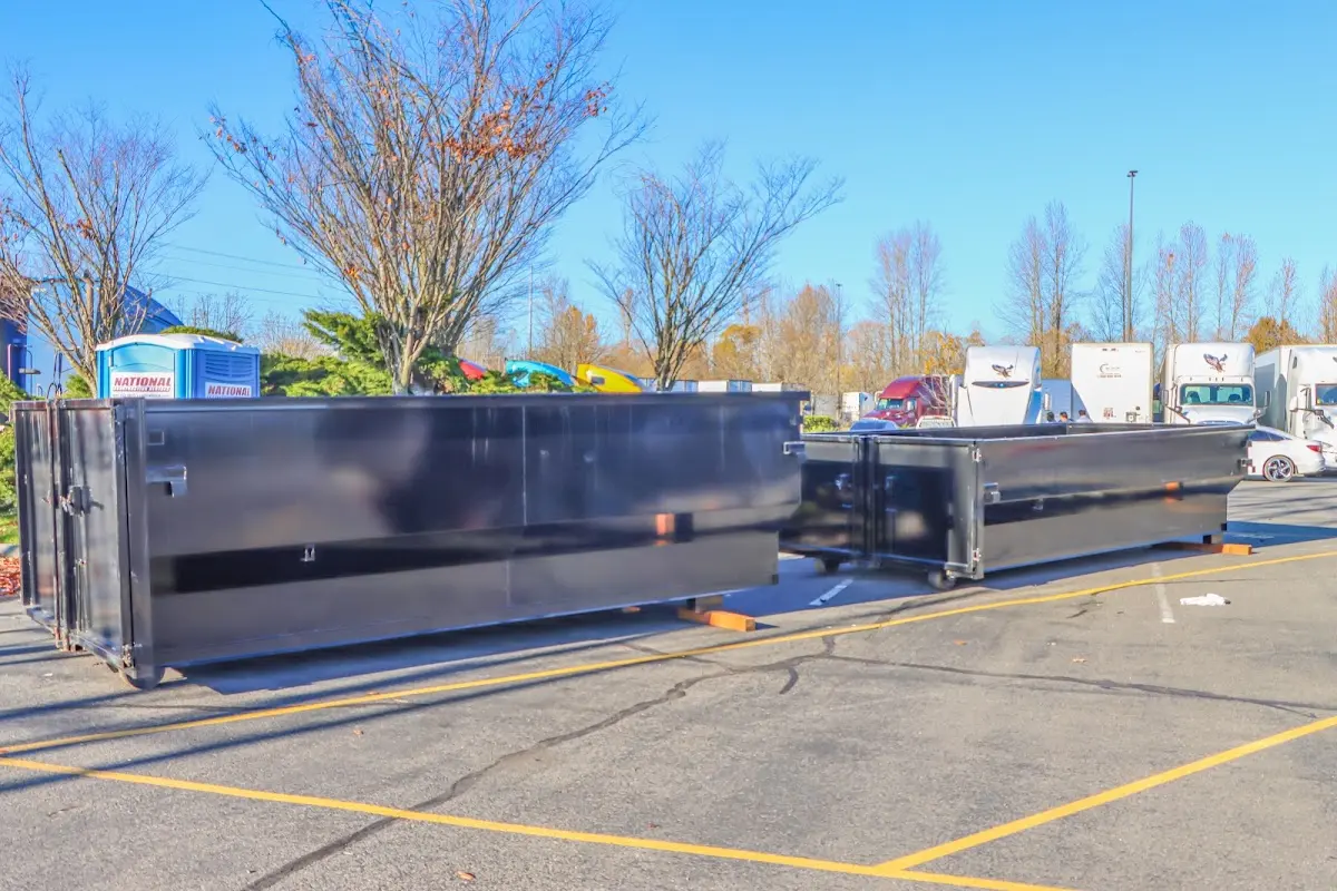 Professional dumpster rental service with roll-off container on residential driveway in Angier